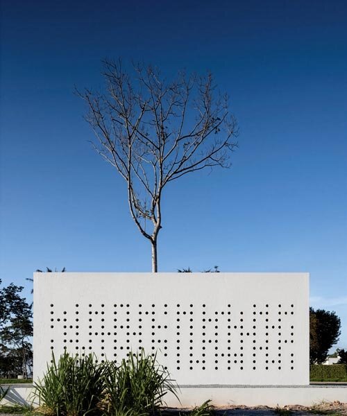 Fehér perforált homlokzat: hibrid otthon és stúdió fa körül Brazíliában!