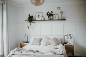 Scandinavian style bedroom featuring minimalist decor, natural light, and indoor plants.