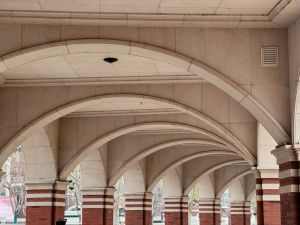 A series of elegant stone arches forming a patterned architectural corridor in Tianjin.