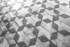 Intricate marble tiles in a geometric 3D star pattern for a modern aesthetic.