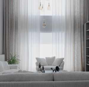 A minimalist living room with soft white sofas and large curtains, creating a cozy atmosphere.