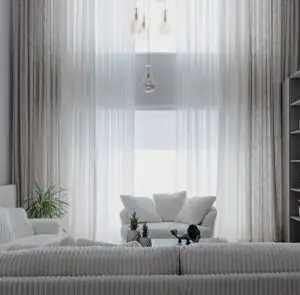 A minimalist living room with soft white sofas and large curtains, creating a cozy atmosphere.