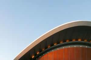 Architectural detail of the House of World Cultures' roof in Berlin, Germany under a clear blue sky.