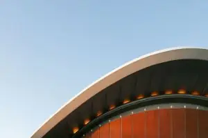 Architectural detail of the House of World Cultures' roof in Berlin, Germany under a clear blue sky.