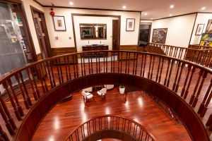 Elegant hotel interior showcasing wooden railings and luxury design. Perfect for upscale hospitality.