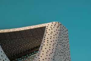Abstract view of a modern architectural facade against a clear blue sky in Dubai.
