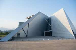 Contemporary geometric building with angular design under clear skies.